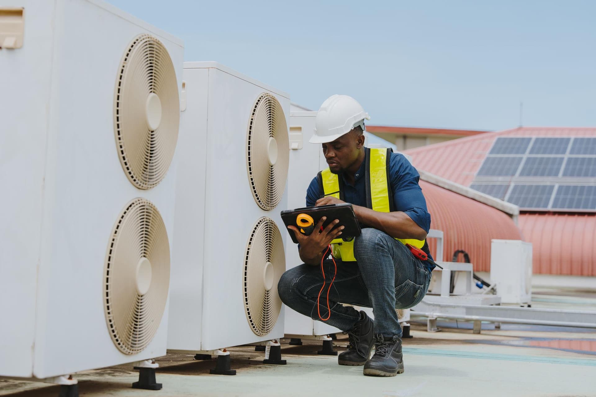 Technician assessing commercial airflow and HVAC balancing
