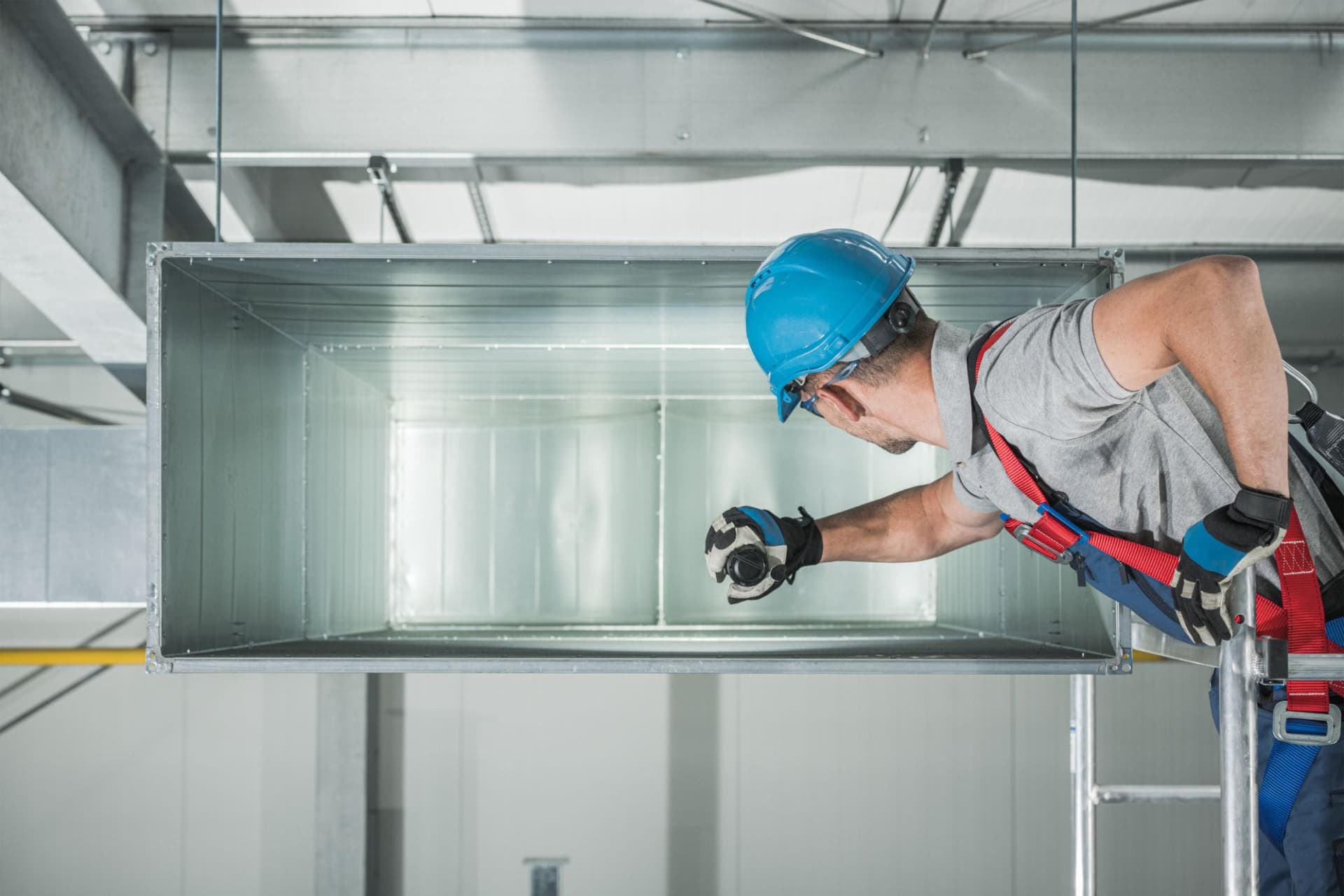 Technician performing an air balancing assessment