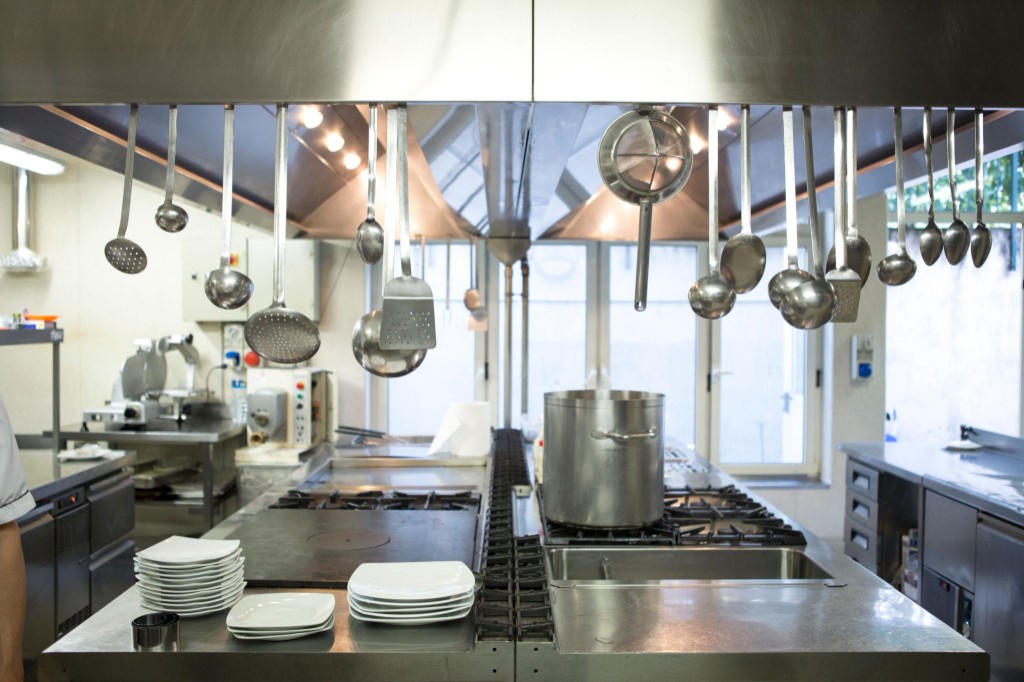 Stainless steel commercial kitchen with professional cooking equipment at Bella Italia