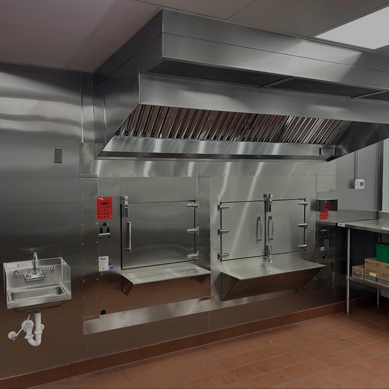 Stainless steel commercial hoods and heavy-duty ovens at Spice & Smoke BBQ