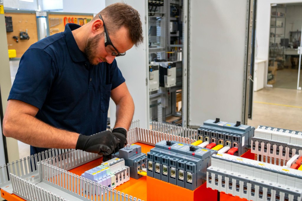 Licensed electrician assembling a commercial electrical control panel