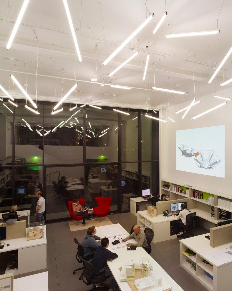 Modern commercial office interior with architectural lighting and collaborative workspace
