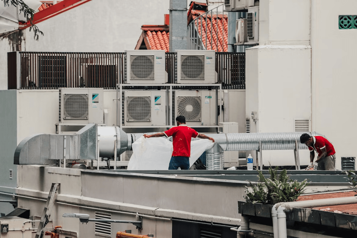 Technician servicing rooftop HVAC equipment at a commercial building in Colorado