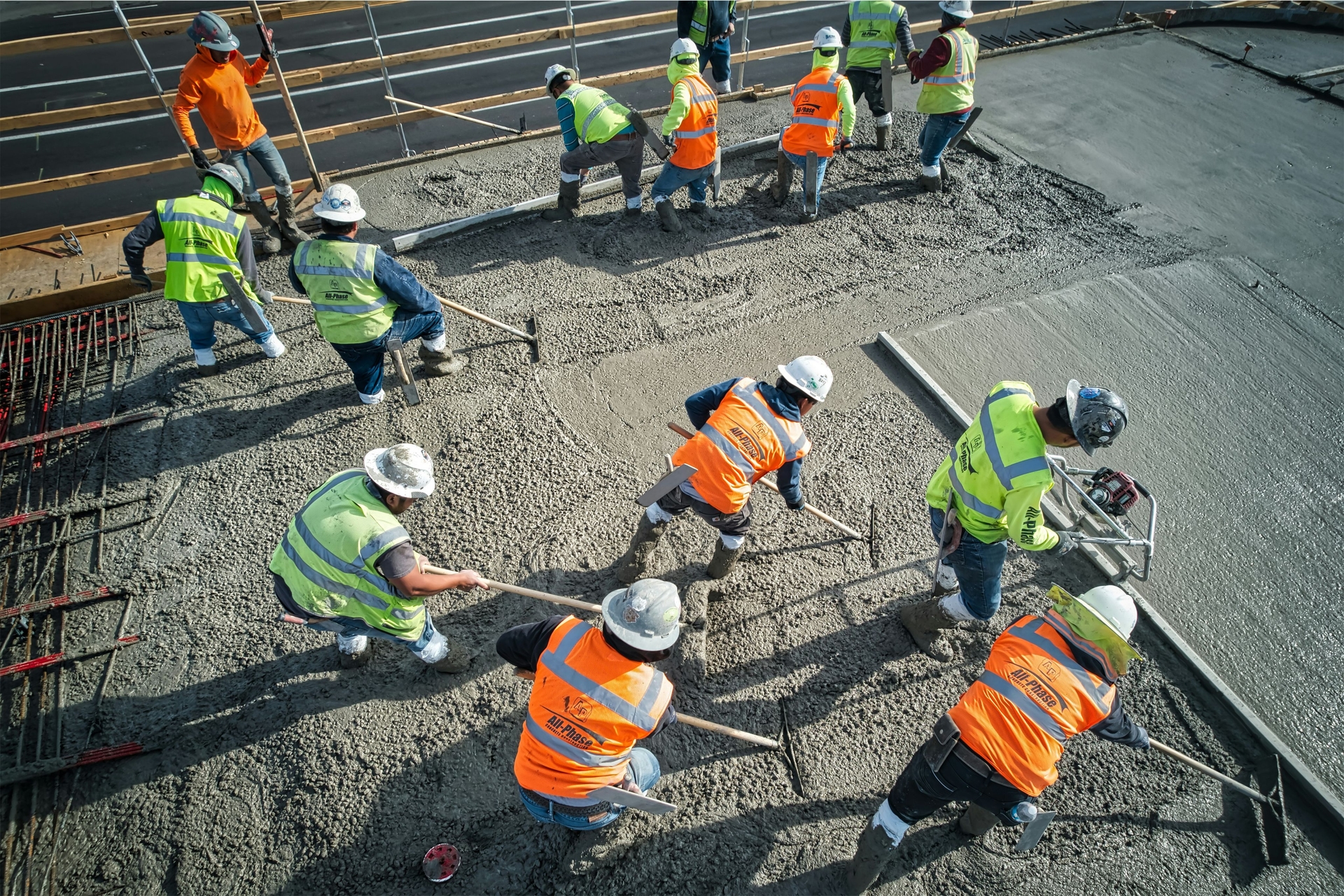 Construction workers leveling concrete